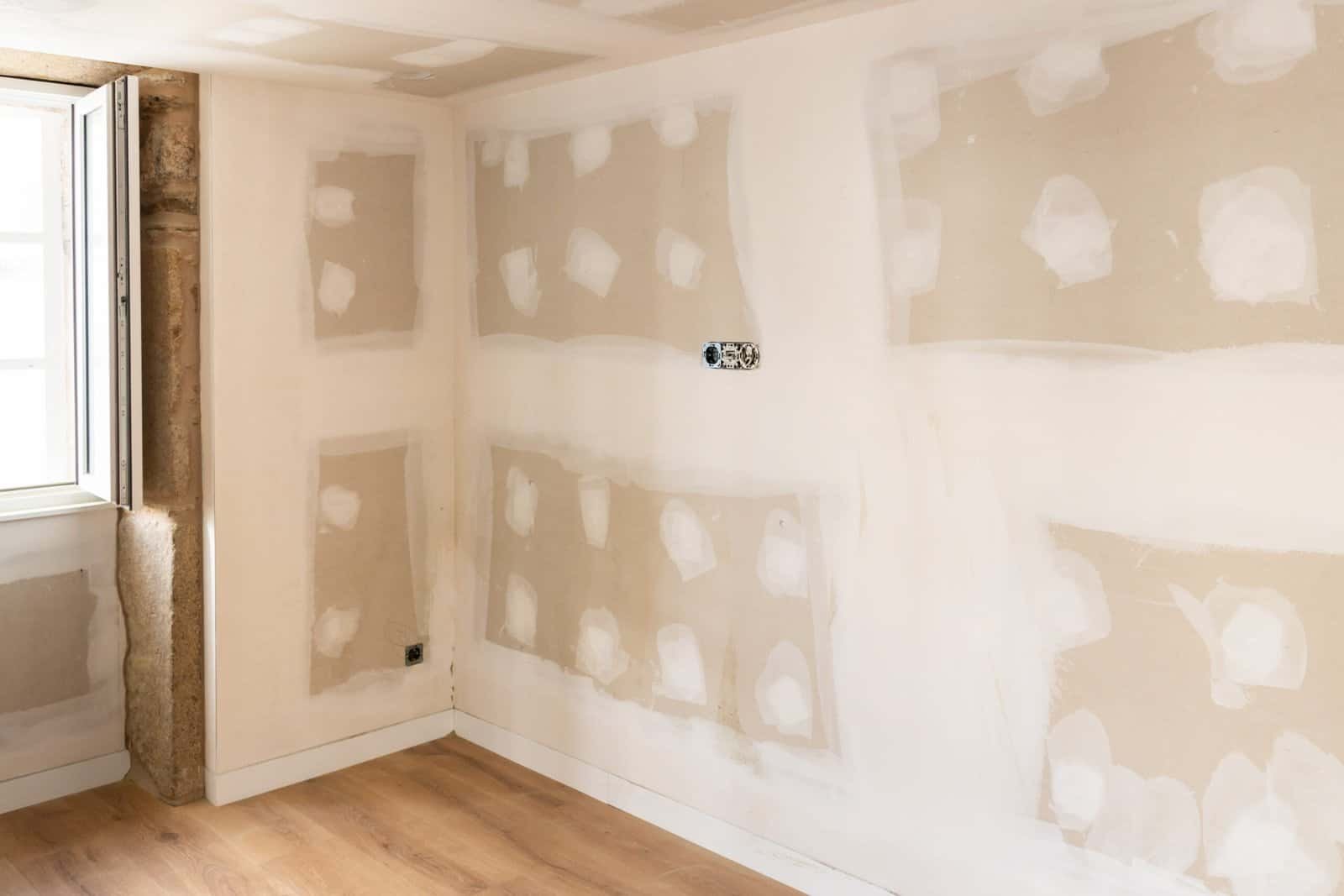 Room with drywall installation in progress for home renovation.